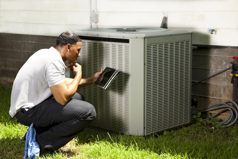 Technician about to perform AC maintenance at residential home in Houston, TX.