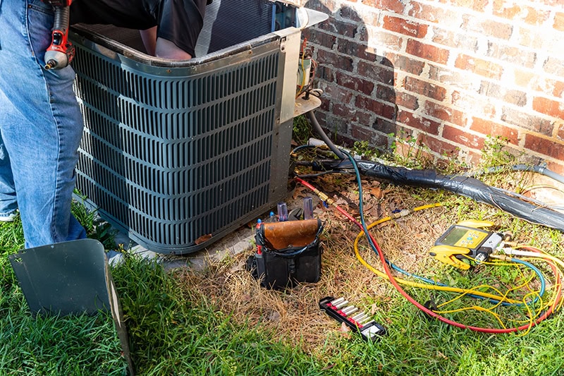 Air conditioner maintenance being performed.
