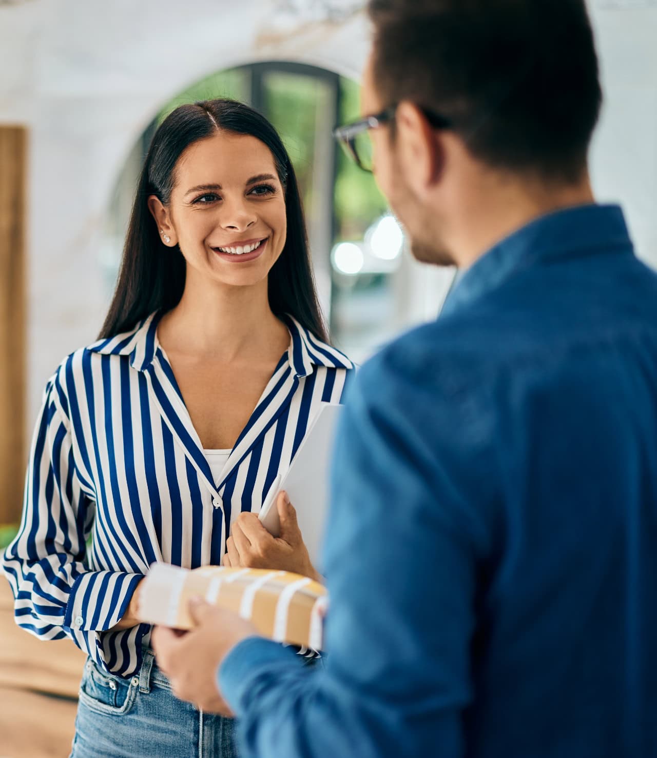 Houston, Texas, homeowner greeting Texas Pride AC & Heating employee at front door.