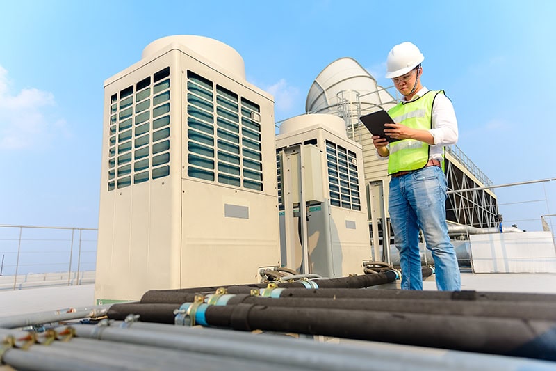 Commercial Tech on roof services GVAC units.